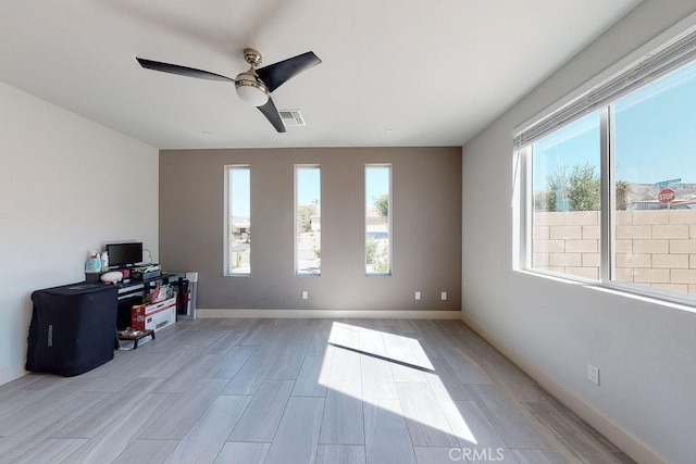 office area with a healthy amount of sunlight, baseboards, and visible vents