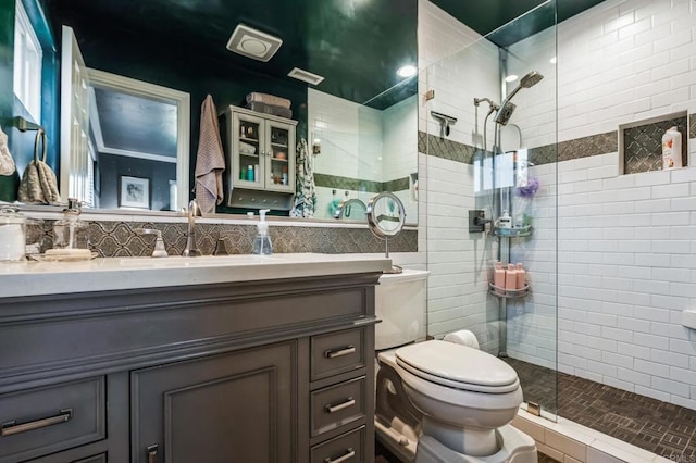 full bath featuring tile walls, tasteful backsplash, toilet, vanity, and walk in shower