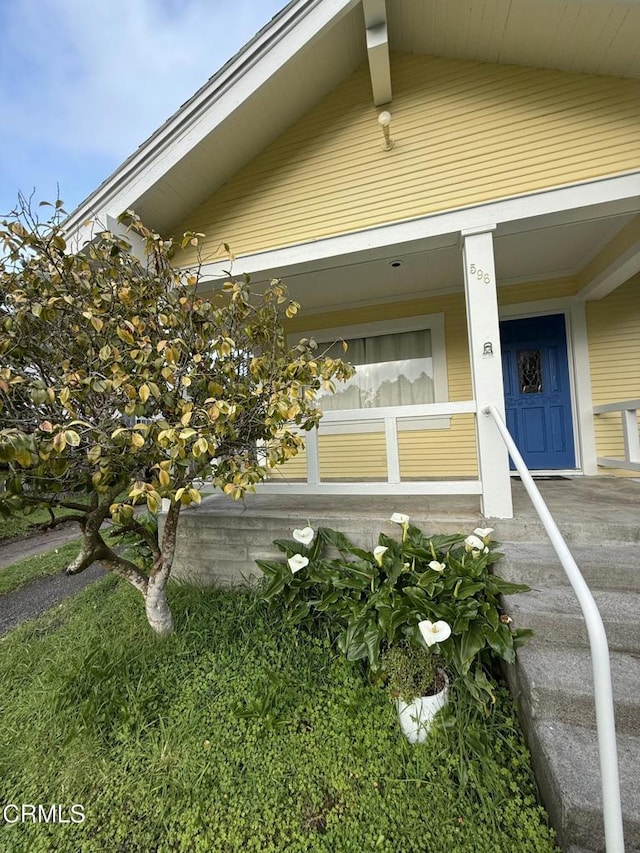 view of exterior entry featuring a porch