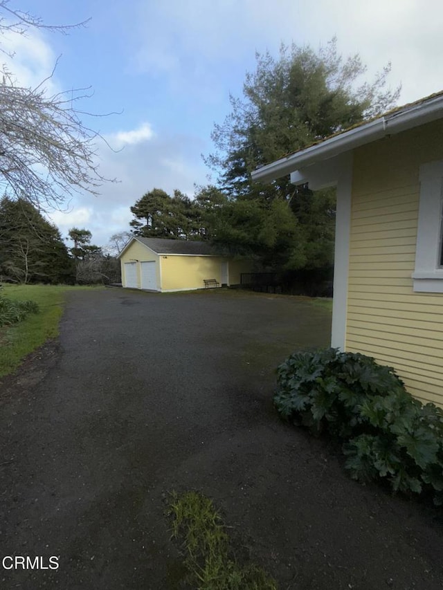 exterior space with an outdoor structure and a garage