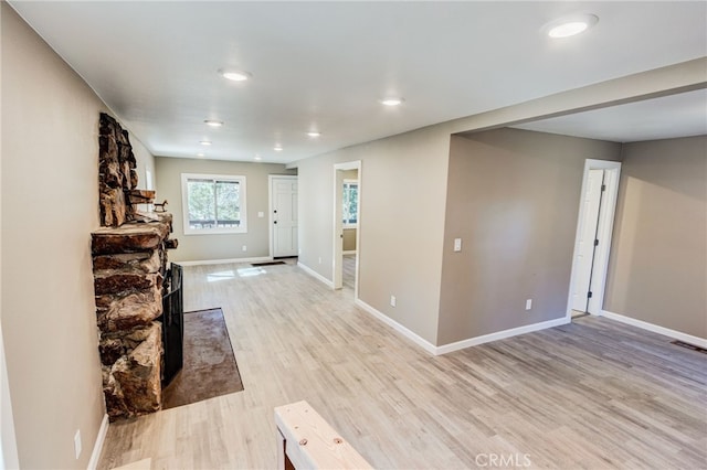 foyer entrance with light wood-style floors, recessed lighting, visible vents, and baseboards