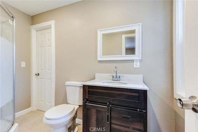 bathroom featuring toilet, vanity, and baseboards