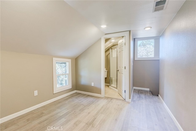 bonus room with a wealth of natural light, light wood-type flooring, visible vents, and baseboards