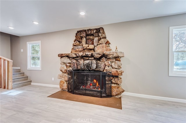 interior details featuring a fireplace, baseboards, and wood finished floors