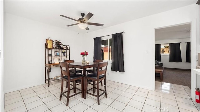 dining space featuring light tile patterned floors and a ceiling fan