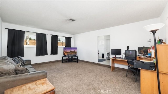 carpeted office with visible vents and baseboards