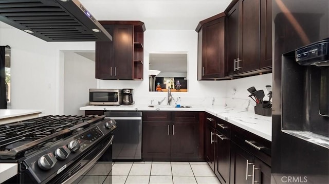 kitchen featuring light tile patterned flooring, stainless steel appliances, a sink, open shelves, and custom range hood