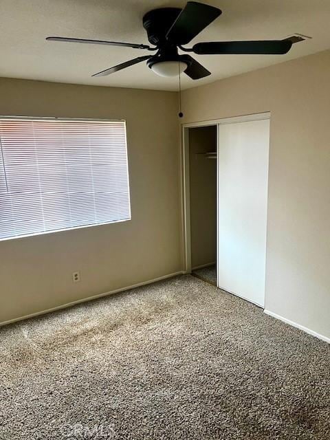 unfurnished bedroom with a closet, ceiling fan, and baseboards