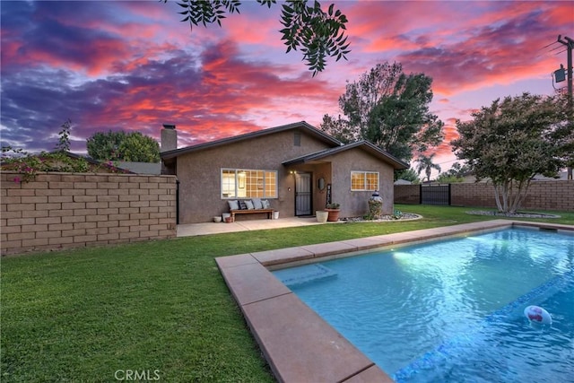 view of pool with a yard, a patio area, a fenced backyard, and a fenced in pool