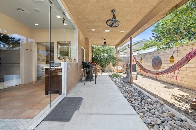 view of patio / terrace featuring a fenced backyard, visible vents, and a ceiling fan