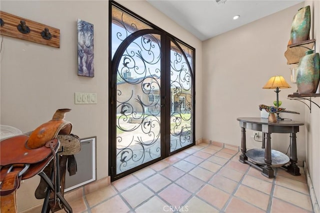 entryway with light tile patterned floors, recessed lighting, baseboards, and french doors