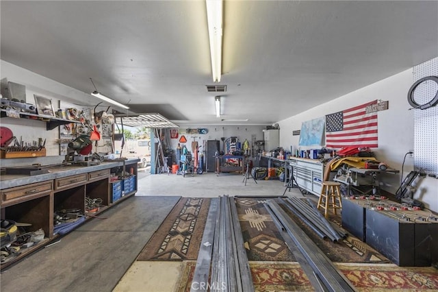 garage featuring visible vents and a workshop area