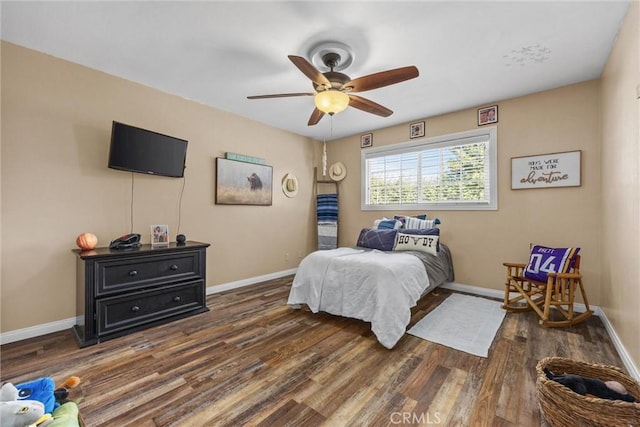 bedroom featuring dark wood-style floors, ceiling fan, and baseboards