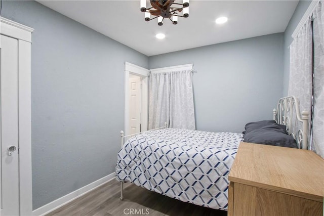 bedroom with a chandelier, recessed lighting, baseboards, and wood finished floors