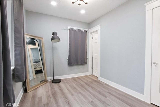 interior space with baseboards and wood finished floors