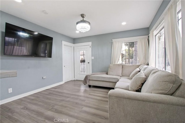 living room with recessed lighting, wood finished floors, and baseboards