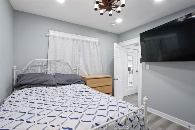 bedroom featuring baseboards and wood finished floors