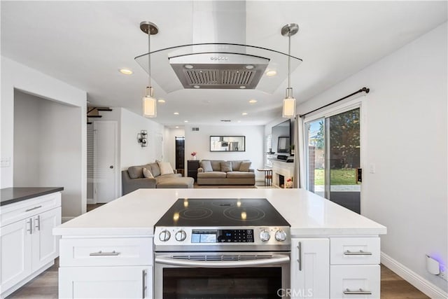 kitchen featuring white cabinets, wood finished floors, decorative light fixtures, stainless steel range with electric stovetop, and recessed lighting