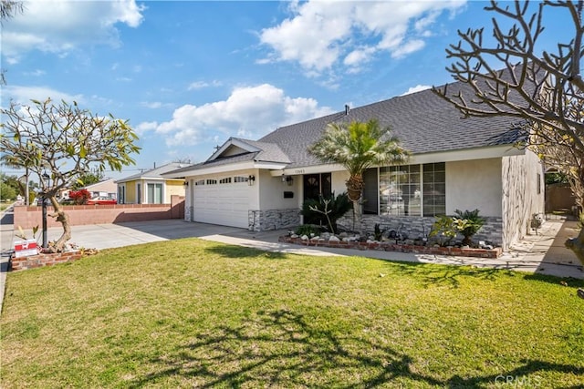 view of front of property with stone siding, a front lawn, concrete driveway, and stucco siding