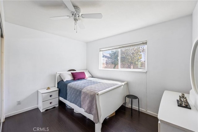 bedroom featuring wood finished floors, a ceiling fan, and baseboards