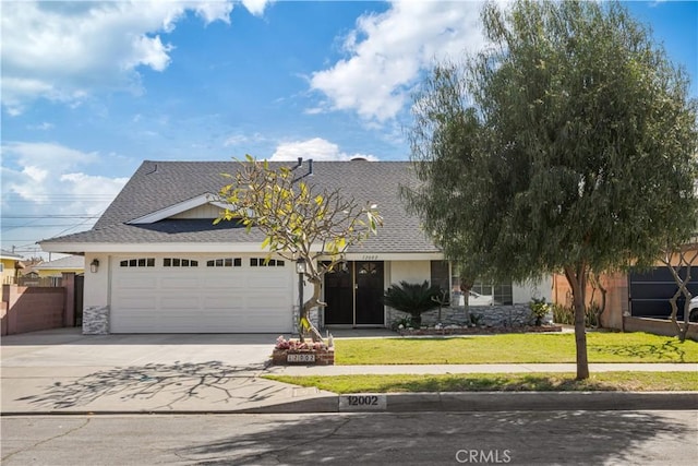 view of front of property featuring driveway, a shingled roof, an attached garage, a front lawn, and stucco siding