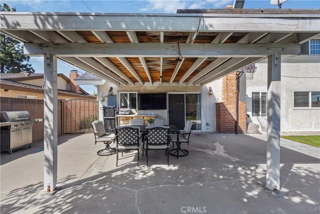 view of patio / terrace with outdoor dining space, fence, and grilling area