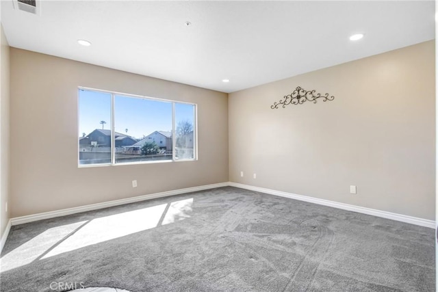 carpeted empty room featuring recessed lighting, visible vents, and baseboards