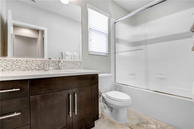 full bathroom featuring combined bath / shower with glass door, tasteful backsplash, vanity, and toilet