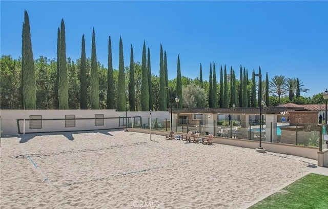 surrounding community with fence and volleyball court