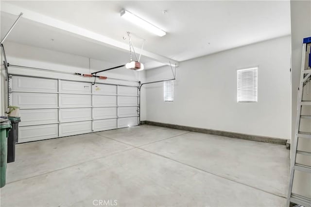 garage with baseboards and a garage door opener