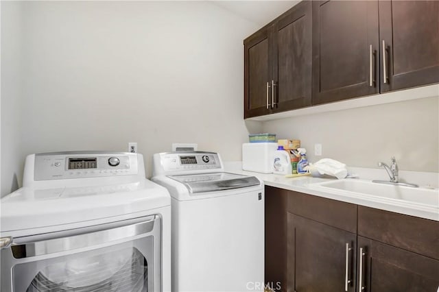 laundry area featuring a sink, cabinet space, and washer and dryer