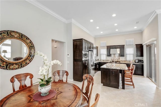 dining space with light tile patterned floors, a toaster, ornamental molding, and recessed lighting