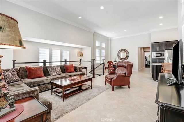 living area with ornamental molding, a wealth of natural light, and recessed lighting