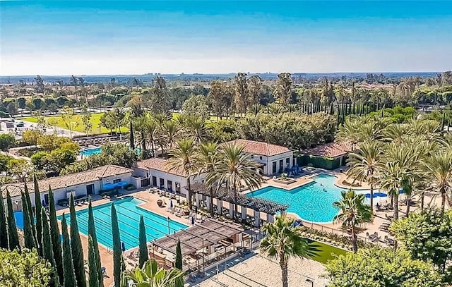 pool with a patio area and fence