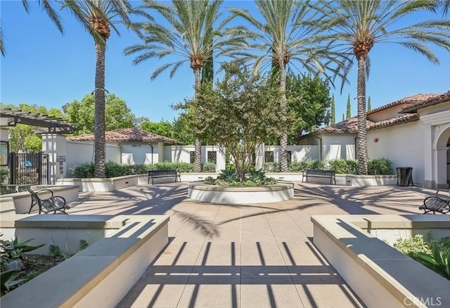 view of community featuring a patio and fence