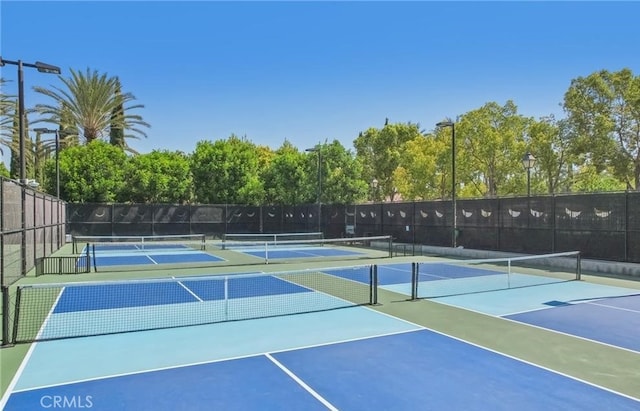 view of sport court featuring fence