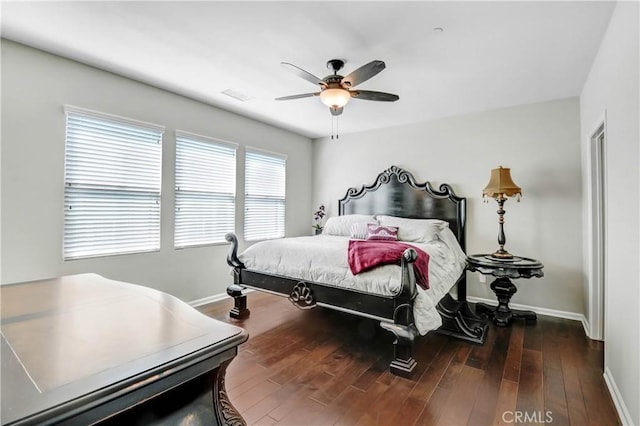 bedroom featuring wood finished floors, a ceiling fan, and baseboards