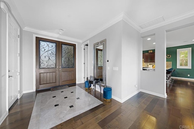 entryway with french doors, dark wood finished floors, recessed lighting, ornamental molding, and baseboards