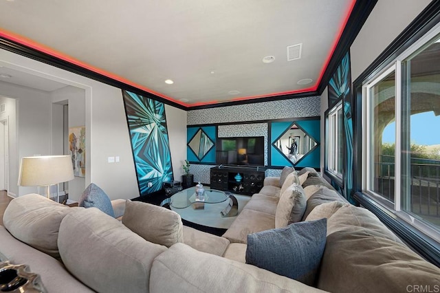 living room with wallpapered walls, visible vents, an accent wall, ornamental molding, and recessed lighting