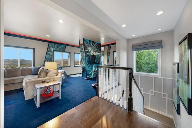 game room with dark wood-style flooring, a mountain view, and recessed lighting