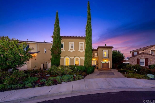 mediterranean / spanish home with driveway, a garage, and stucco siding