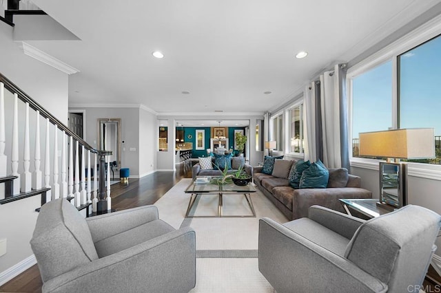 living room featuring recessed lighting, wood finished floors, baseboards, ornamental molding, and stairway