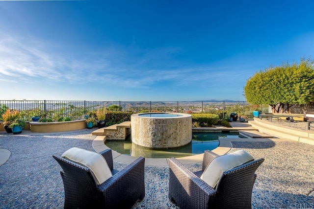 view of patio featuring a fenced in pool, an outdoor hot tub, and fence