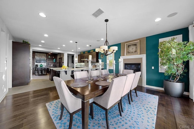 dining room featuring a chandelier, recessed lighting, visible vents, and dark wood finished floors