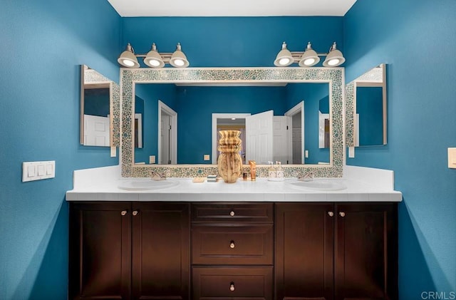 bathroom with a sink and double vanity