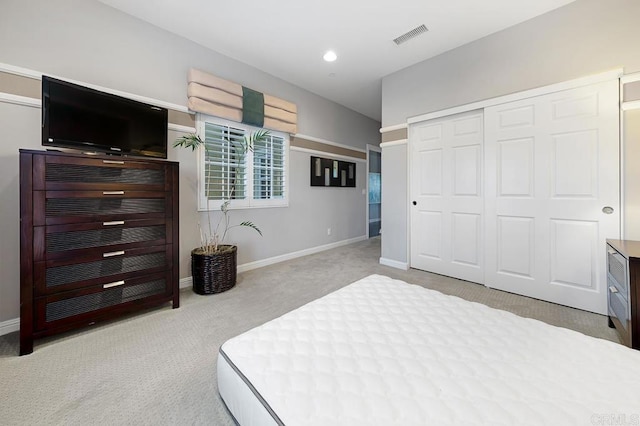 bedroom featuring recessed lighting, a closet, visible vents, light carpet, and baseboards