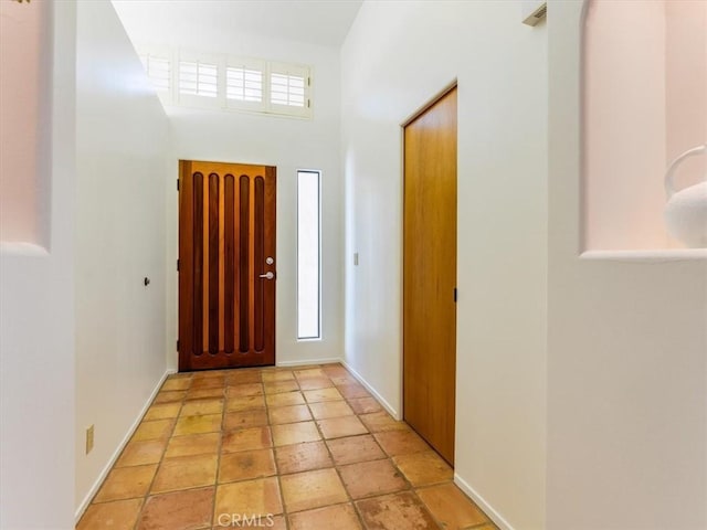 foyer entrance featuring baseboards and a healthy amount of sunlight