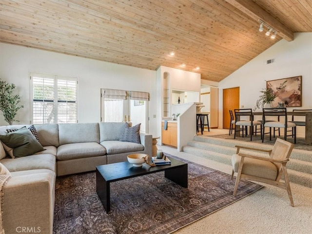 carpeted living area featuring high vaulted ceiling, a wealth of natural light, wooden ceiling, and beamed ceiling