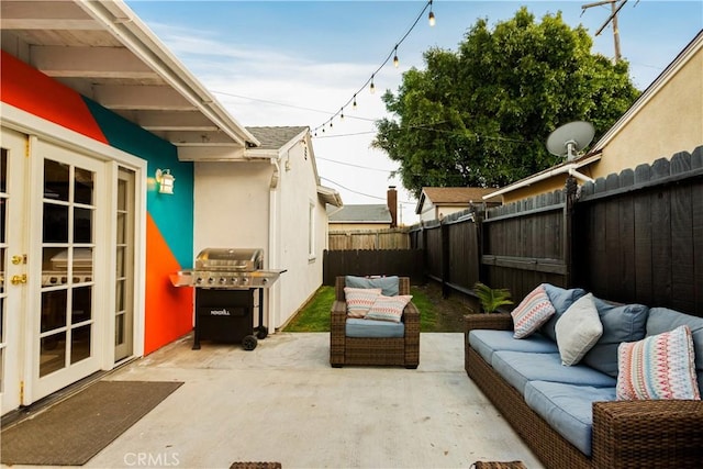 view of patio / terrace with a grill, an outdoor hangout area, a fenced backyard, and french doors