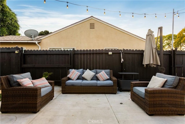 view of patio / terrace featuring outdoor lounge area and fence